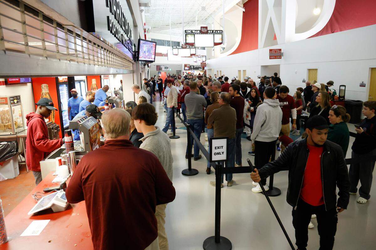 South Carolina fans wait for free concessions while their team plays Elon at Colonial Life Arena on Friday, December 22, 2023. 