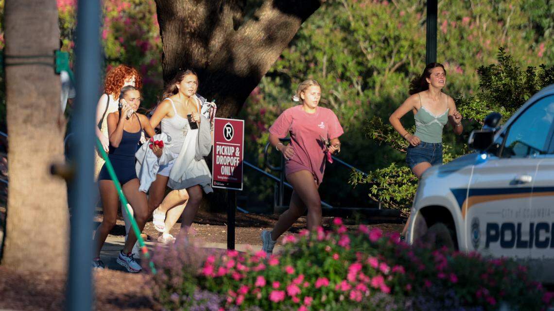 Students run down Greene Street after being evacuated at the University of South Carolina after reports of the sounds of gunfire on campus at the Thomas Cooper Library on Sunday, August 25, 2025.