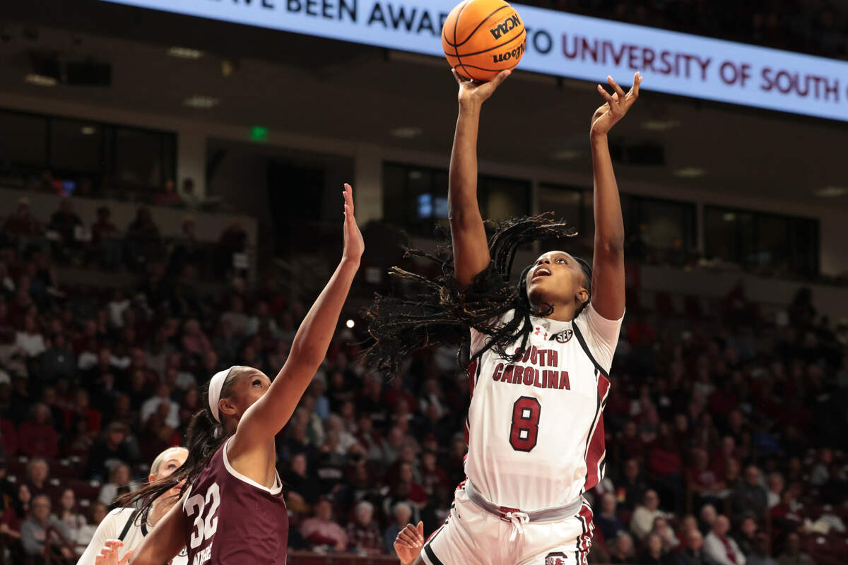 University of South Carolina’s Joyce Edwards (8) shoots as Texas A&M’s Lauren Ware (32) defends during the first half of action in the Colonial Life Arena on Thursday, Jan. 9, 2025.