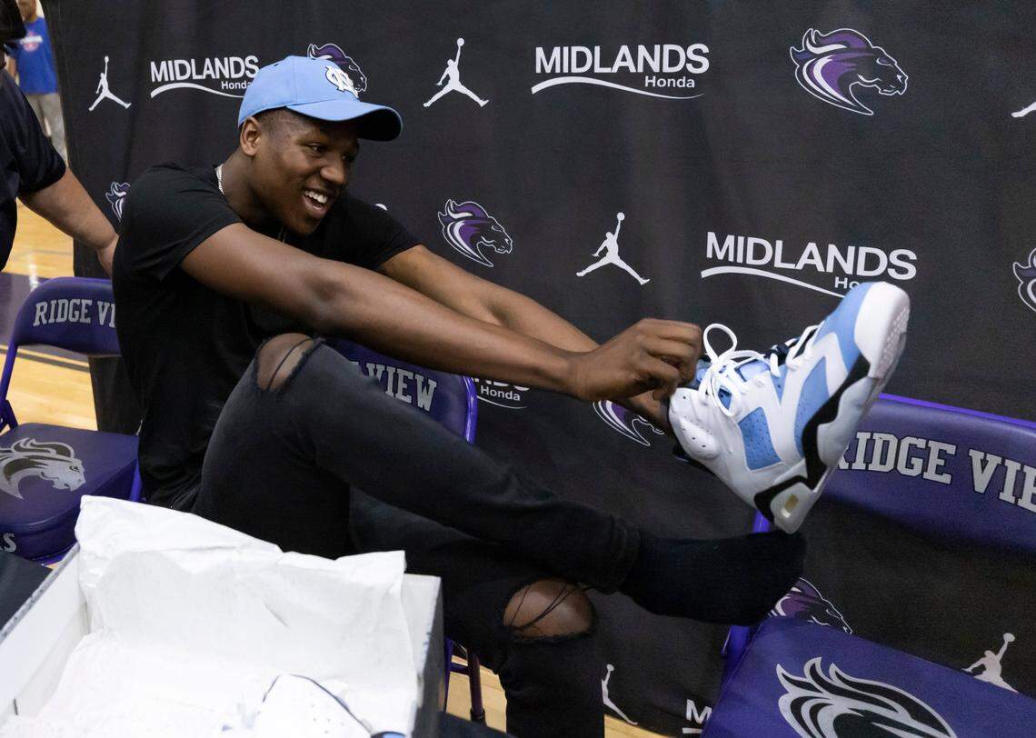 Five-star basketball player GG Jackson, who announced his decision to attend the University of North Carolina, puts on a pair of blue Air Jordans after speaking to the media on Wednesday, April 27, 2022, in Columbia.