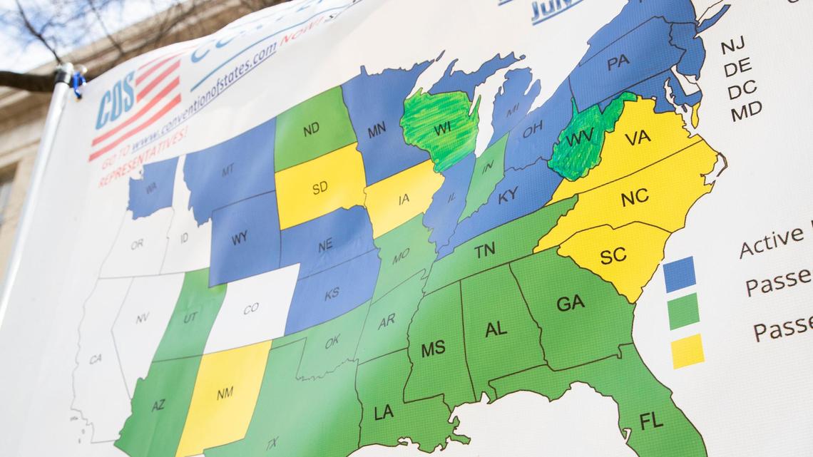 Protesters who want a convention of states hold up a map with which states have passed similar measures to what South Carolina lawmakers are currently debating at the State House in Columbia, South Carolina on Tuesday, March 8, 2022.