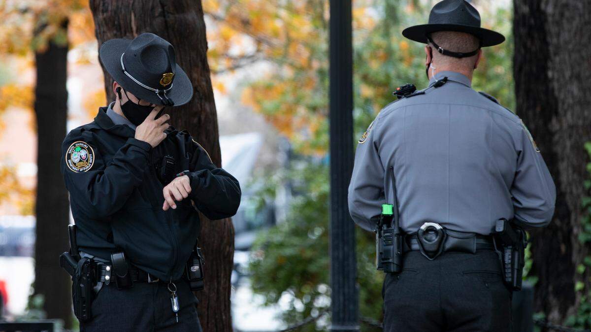 Officers with the S.C. Bureau of Protective Services stand near two protests at the South Carolina State House on Tuesday, Jan. 12, 2021.