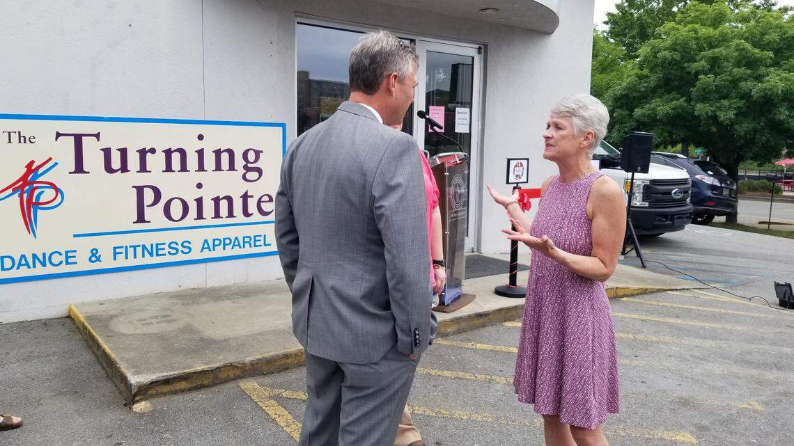 The Turning Pointe owner Coleen Strasburger, right, chats with Columbia Mayor Daniel Rickenmann on May 25, 2022 at the grand opening of the dancewear shop in Columbia’s Five Points.