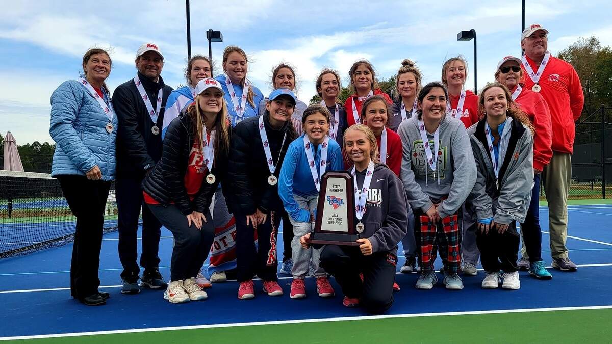 AC Flora players and coaches pose with the runner-up trophy after losing to Lucy Beckham in the Class 4A girls tennis championship on Saturday, Nov. 6, in Cayce, SC.