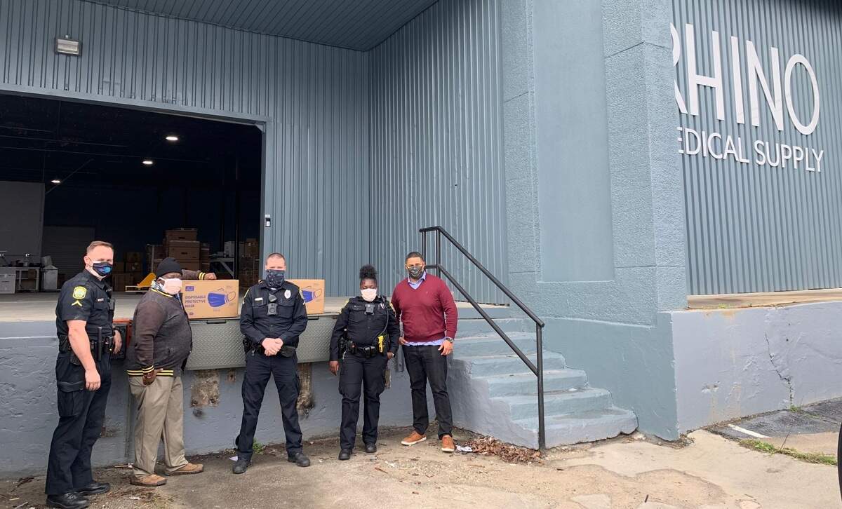 Daniel Avery, Omari Fox, Mike Blackmore, Raven Brewer and Lance Brown stand outside of Rhino Medical Supply after Columbia Police and North Columbia Youth Empowerment Initiative receive mask donations.