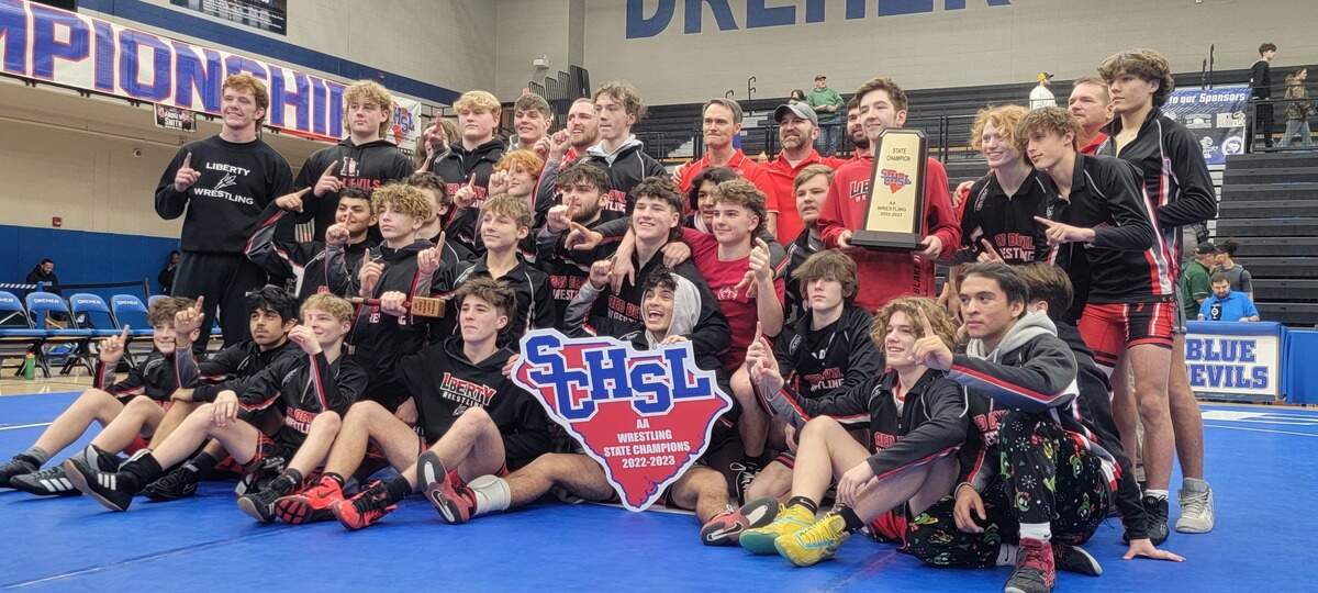 Liberty wrestling celebrates winning the 2023 Class 2A state championship.