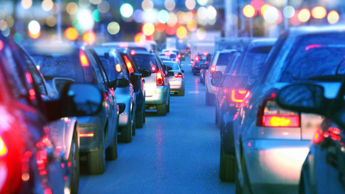 Cars driving during a traffic jam during rush hour.