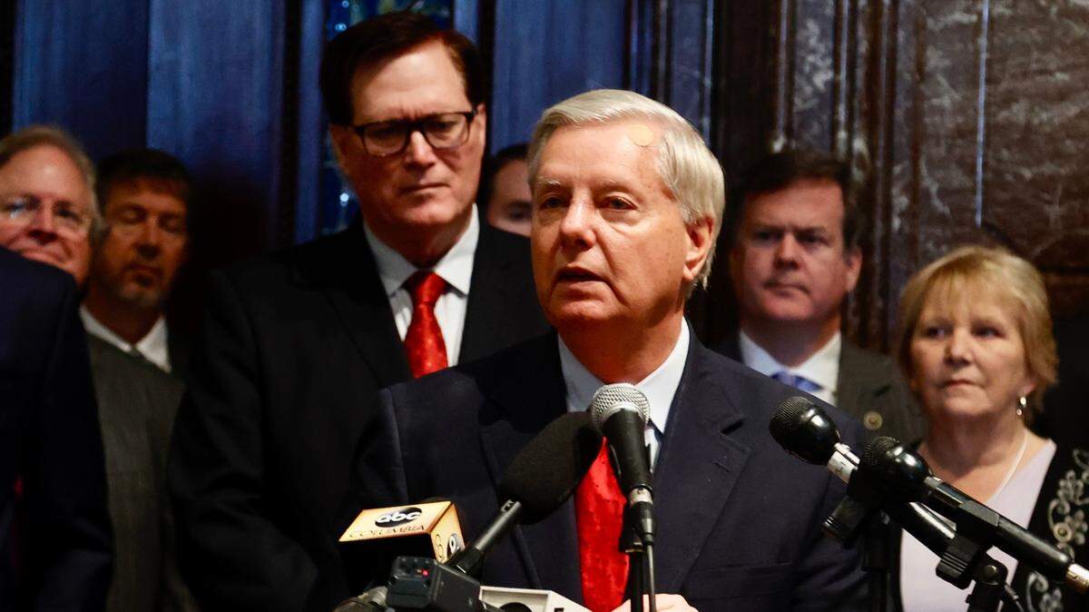 U.S. Sen. Lindsey Graham, R-S.C., speaks at the S.C. State House in Columbia, S.C. surrounded by state lawmakers on Tuesday, Jan. 25, 2022.