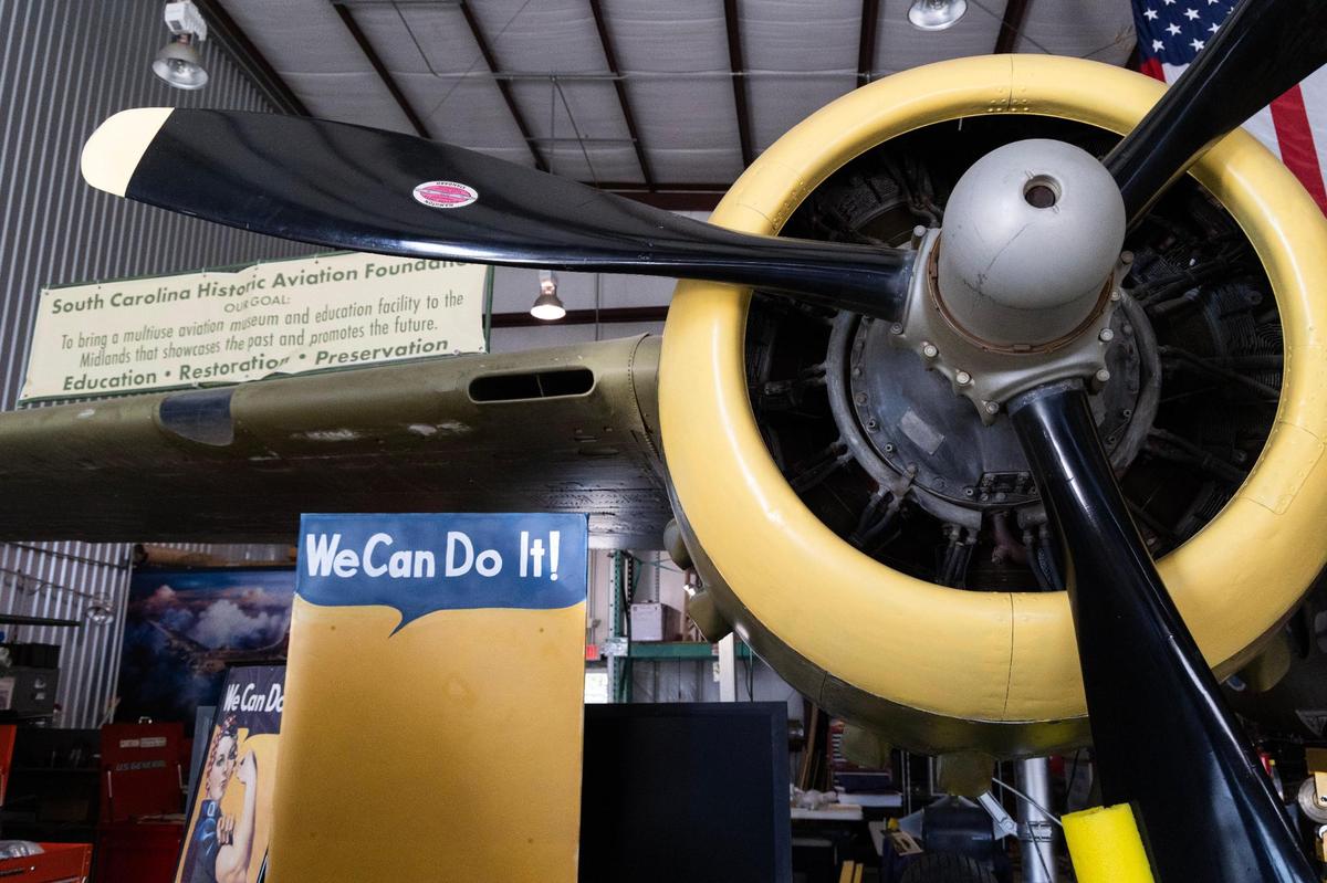 Ron Skipper and Katherine Cuddy show a restored B-25c at Owens Field Airport on Monday, August 7, 2023.