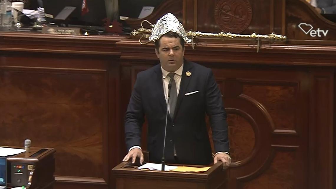 State Rep. Micah Caskey, R-Lexington, wears a tin foil hat on the House floor while speaking about a proposal to allow gold and silver to be used as legal tender in South Carolina on Wednesday, May 8, 2024.