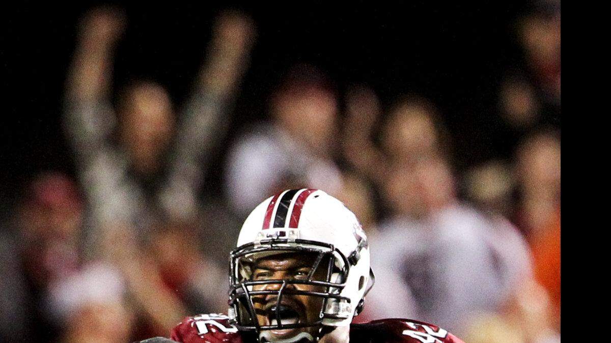 University of South Carolina’s Travian Robertson celebrates tackling Clemson quarterback Tajh Boyd in the second half at William-Brice Stadium in Columbia, S.C..