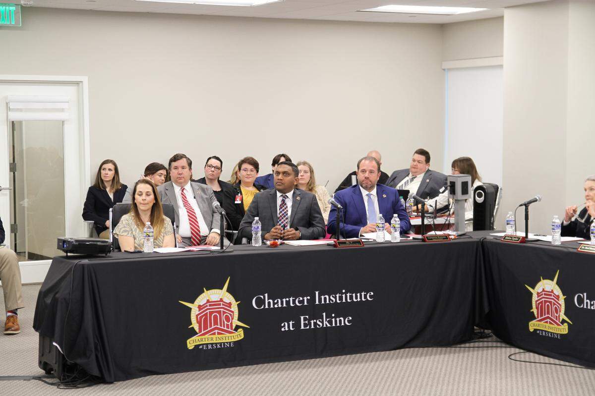 Charter Institute at Erskine CEO and Superintendent Cameron Runyan (front right) listens to presentations by charter school applicants on April 17, 2024.