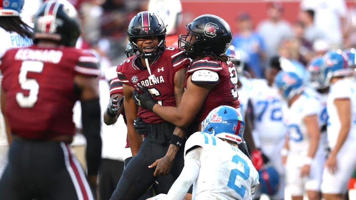 South Carolina defensive tackle TJ Sanders pulls Dylan Stewart away from Ole Miss QB Jaxson Dart after Stewart did a fake gun celebration after a sack.