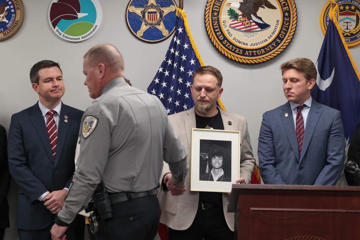 York County Sheriff Tony Breeden acknowledges Brandon Guffey during a Jan. 27 press conference after the indictment of a Nigerian man who is charged with extortion of Guffey’s son, Gavin Guffey. Gavin Guffey, 17, took his own life in 2022 after being extorted.