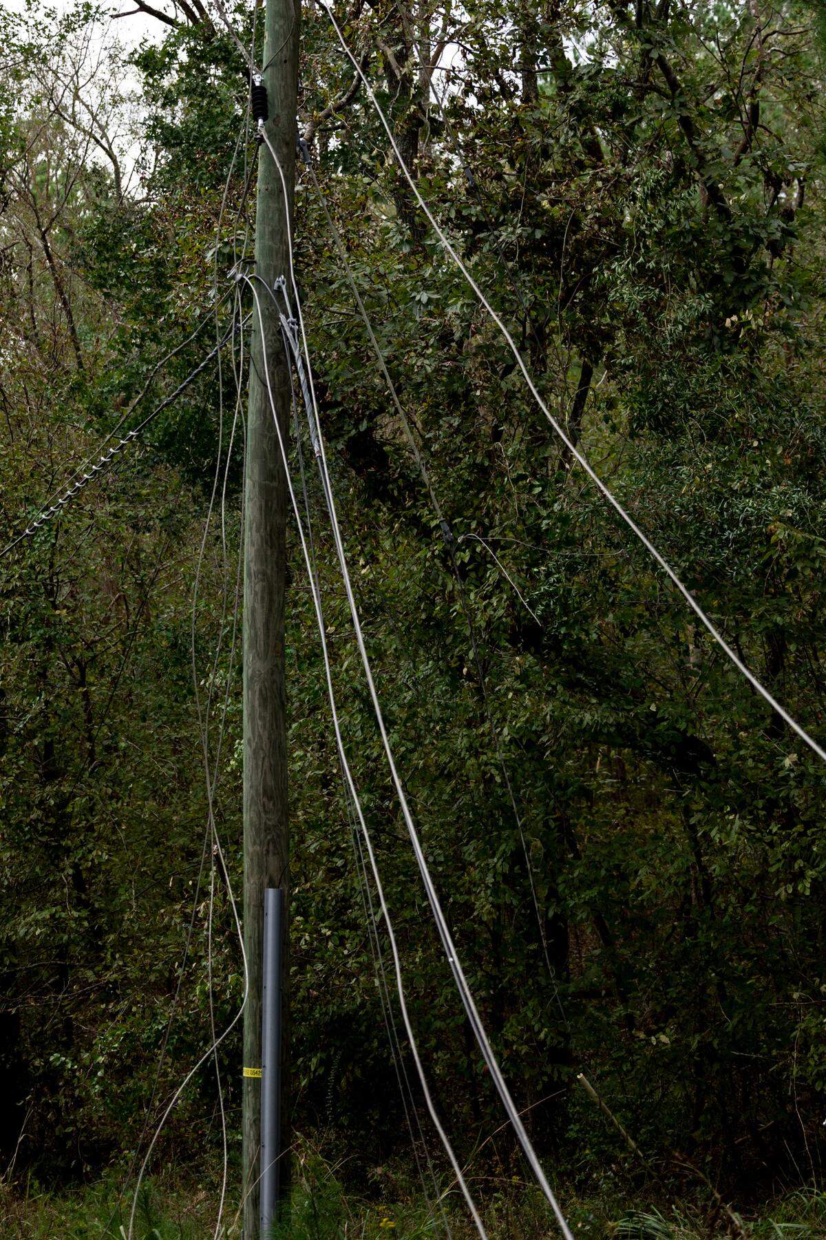 Electrical wires hang from a utility pole along Lanford Road in Edgefield. High winds from Hurricane Helene toppled trees leaving thousands without power. The damage to rural areas is so bad that along many roads, the entire electrical infrastructure needs to be rebuilt.