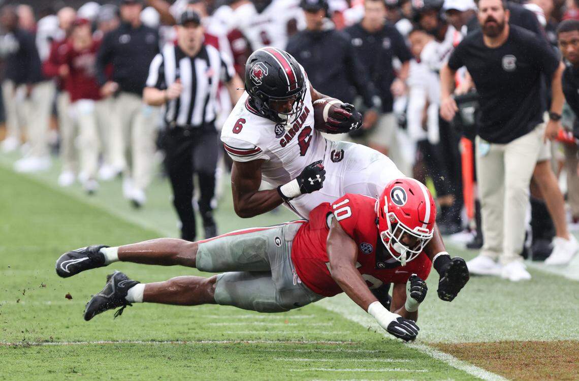 South Carolina tight end Joshua Simon (6) is driven out of bounds by Georgia linebacker Jamon Dumas-Johnson (10) during the second half of the Gamecocks’ game at Sanford Stadium in Athens on Saturday, September 16, 2023.