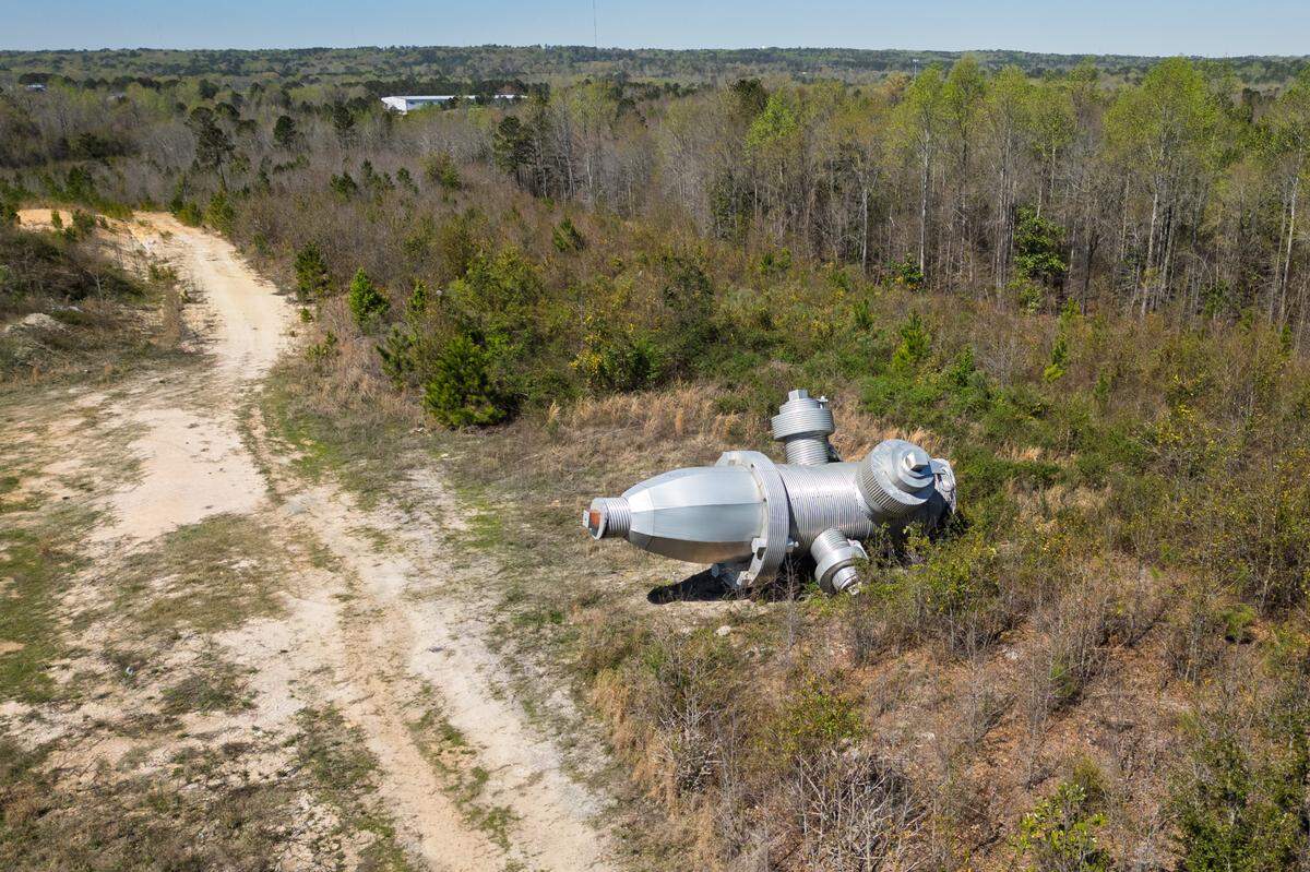 Busted Plug, a sculpture by Columbia artist Blue Sky, lies in a field north of Columbia on Wednesday, March 26, 2025. The 40-foot sculpture was installed in downtown Columbia until 2023.