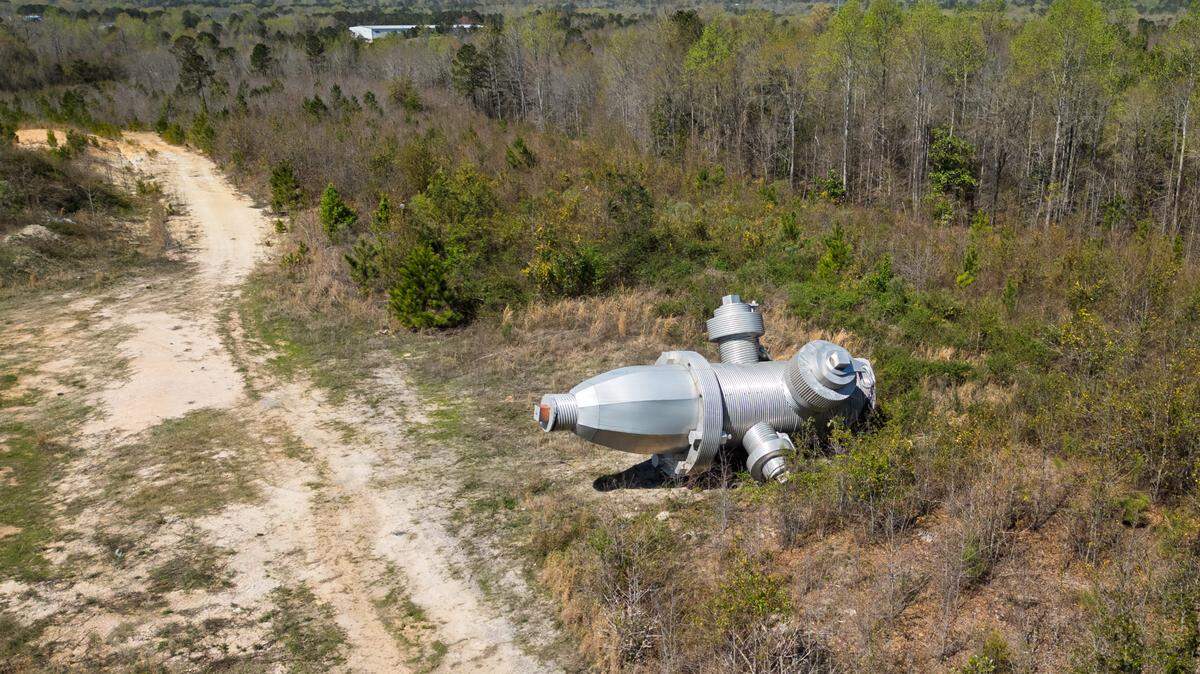 Busted Plug, a sculpture by Columbia artist Blue Sky, lays in a field north of Columbia on Wednesday, March 26, 2025. The 40-foot sculpture was installed in downtown Columbia until 2023.