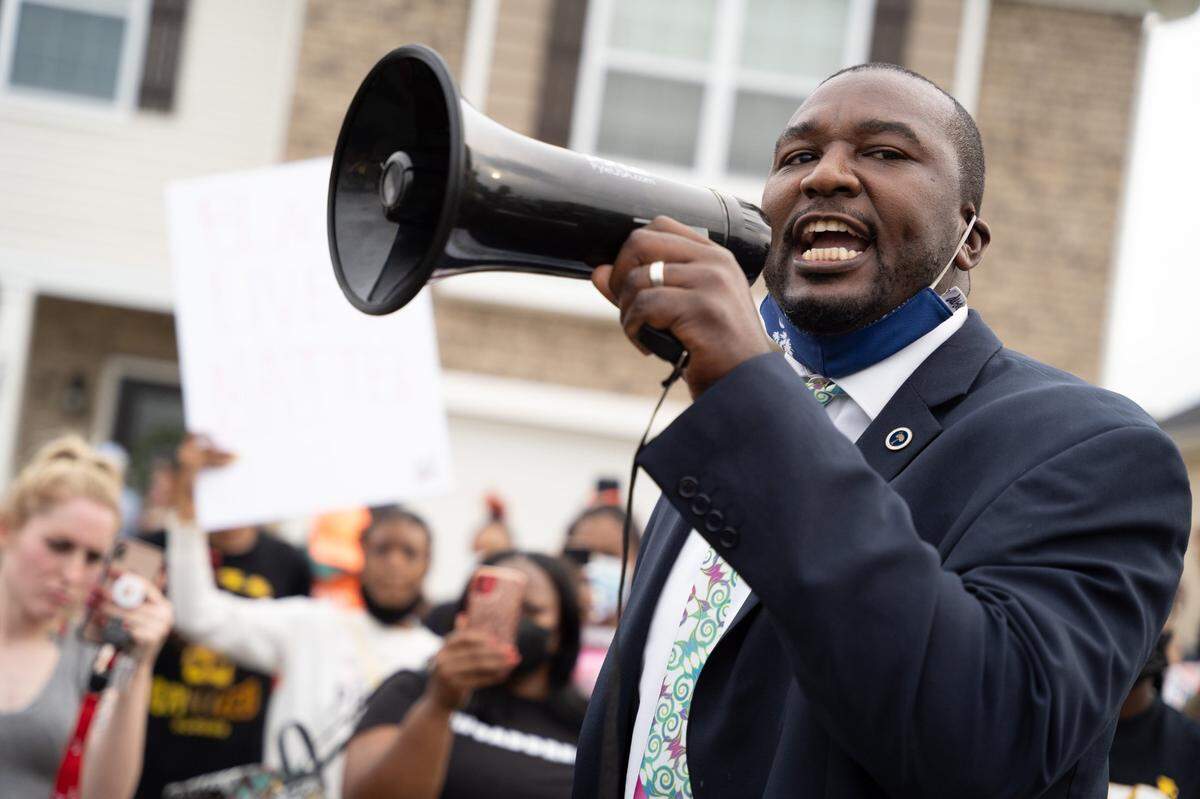 State Rep. Jermaine Johnson, D-Richland, speaks to protestors along Lakemont Drive in the Summit where a Ft. Jackson Army soldier was seen in a viral video pushing and shoving a young Black man the day before in Columbia, SC. The soldier, Jonathan Pentland, has been charged with third-degree assault and battery.