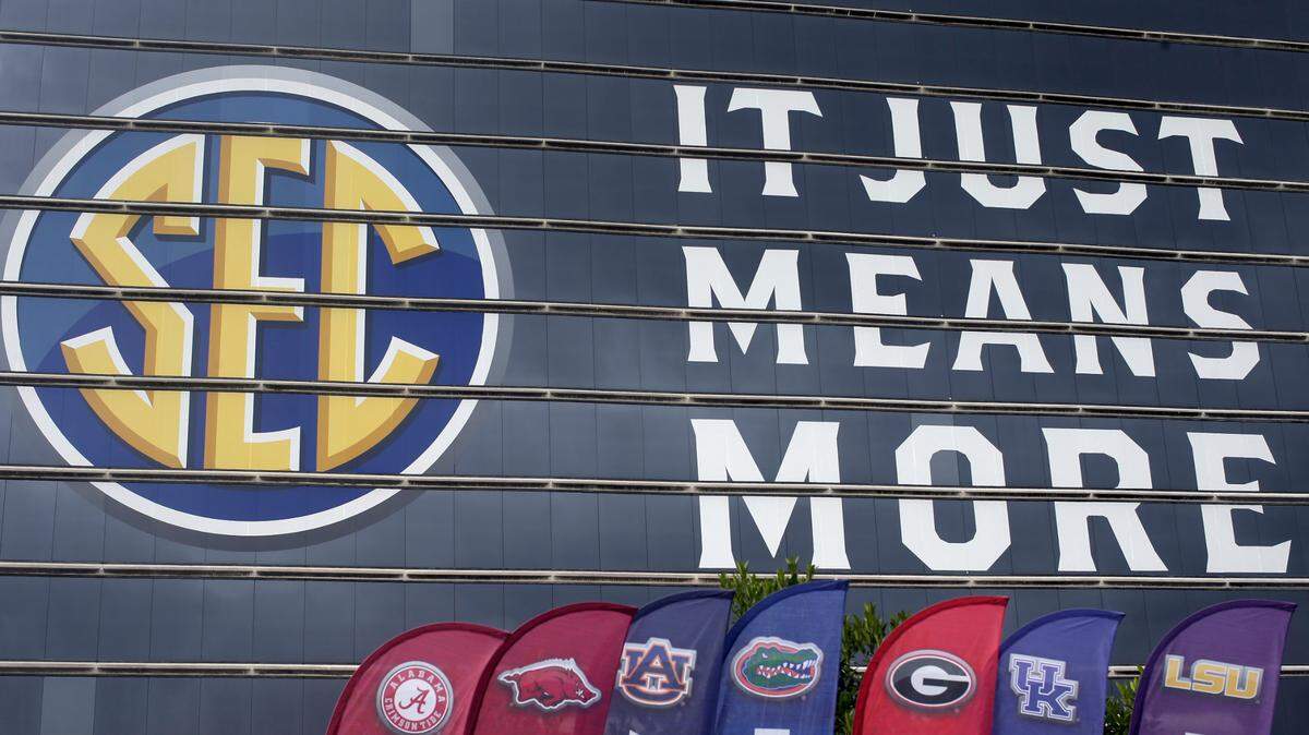 The SEC logo is displayed at the Hyatt Regency hotel, site of the NCAA college football Southeastern Conference Media Days, Monday, July 19, 2021, in Hoover, Ala. (AP Photo/Butch Dill)