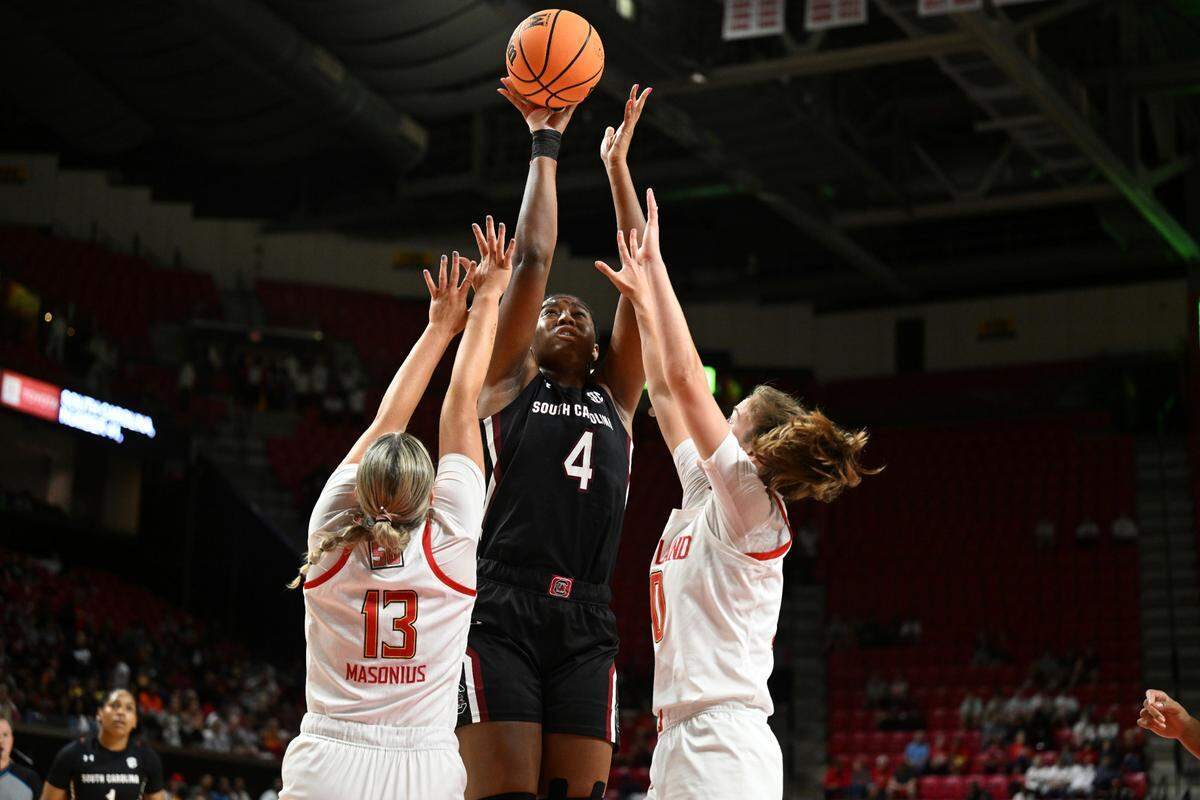 South Carolina’s Aliyah Boston shoots between Maryland’s Faith Masonius, left, and Abby Meyers during the first half of an NCAA college basketball game Friday, Nov. 11, 2022, in College Park, Md. (AP Photo/Gail Burton)