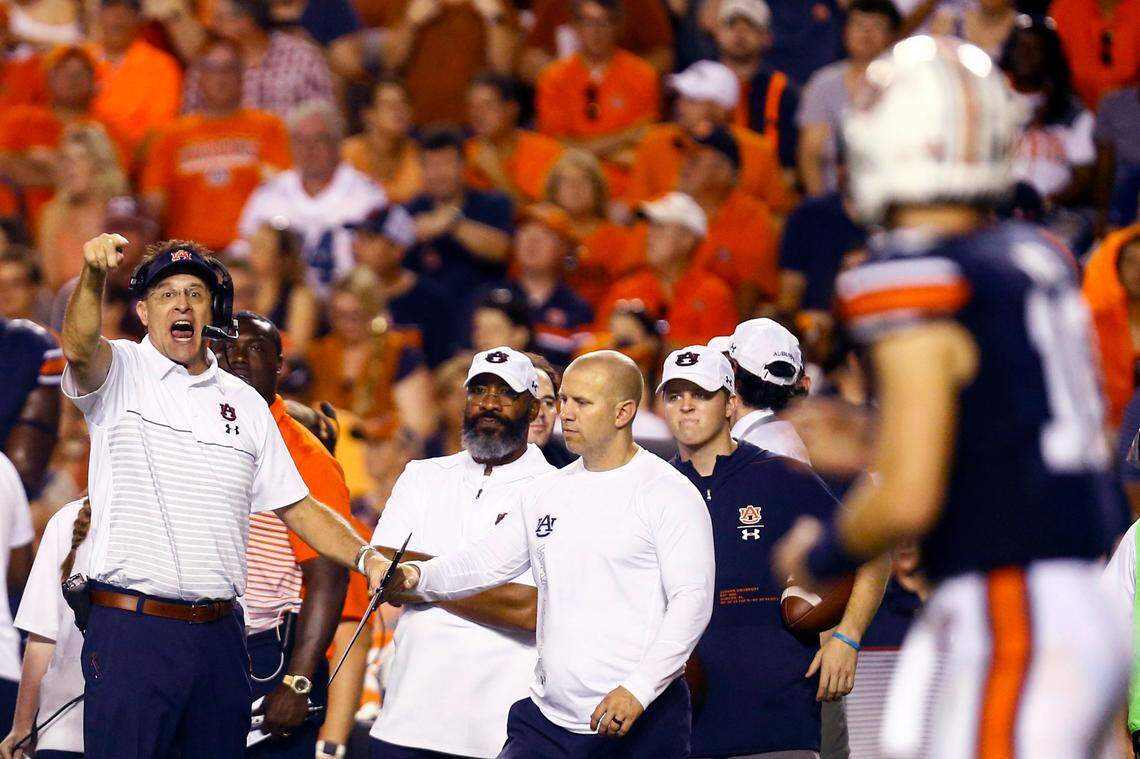 Auburn head coach Gus Malzahn and quarterback Bo Nix (10) now have a new voice in the room after hiring offensive coordinator Chad Morris.