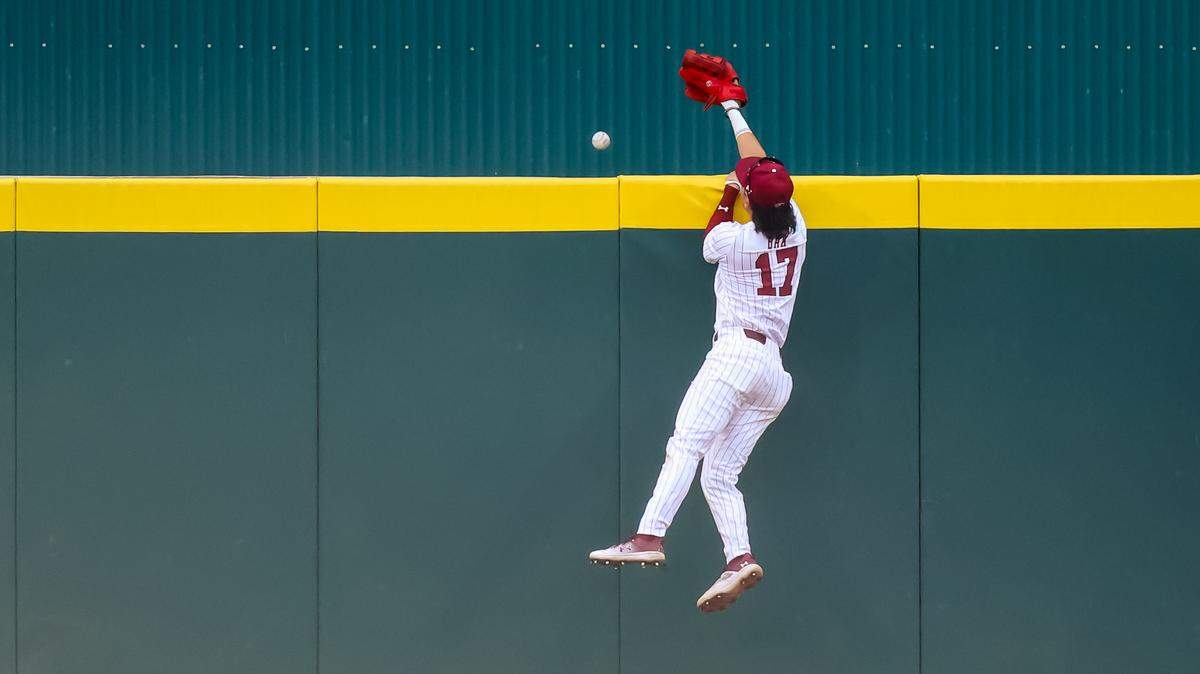 South Carolina Gamecocks CF Tyler Bak (17) leaps but cannot bring back a Razorbacks home run during the game between Arkansas and South Carolina at Founders Park, 3/20/26.