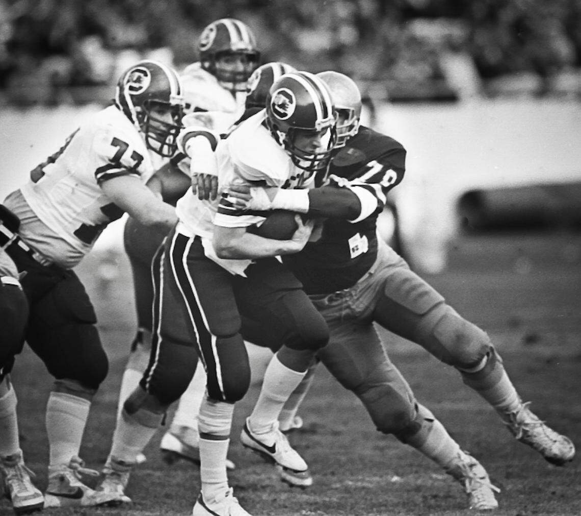 1984 South Carolina Gamecock quarterback Mike Hold is sacked by the Navy defense during their lost to Navy to end their undefeated season. They were ranked number 2 at the time. November 17, 1984