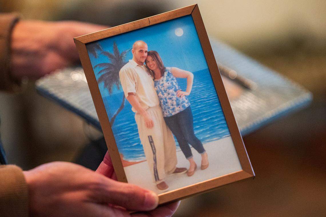 Rose Anna Welch shows a photo of Ben Case in prison.