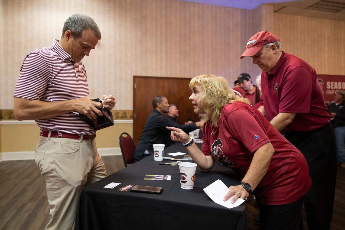 Football head coach Shane Beamer signs autographs for Beth Barton and Scotty Griffin during the Gamecock Welcome Home Banquet, organized by the Lexington and Richalnd County Gamecock Clubs, at Seawell’s in Columbia on Monday, May 8, 2023.