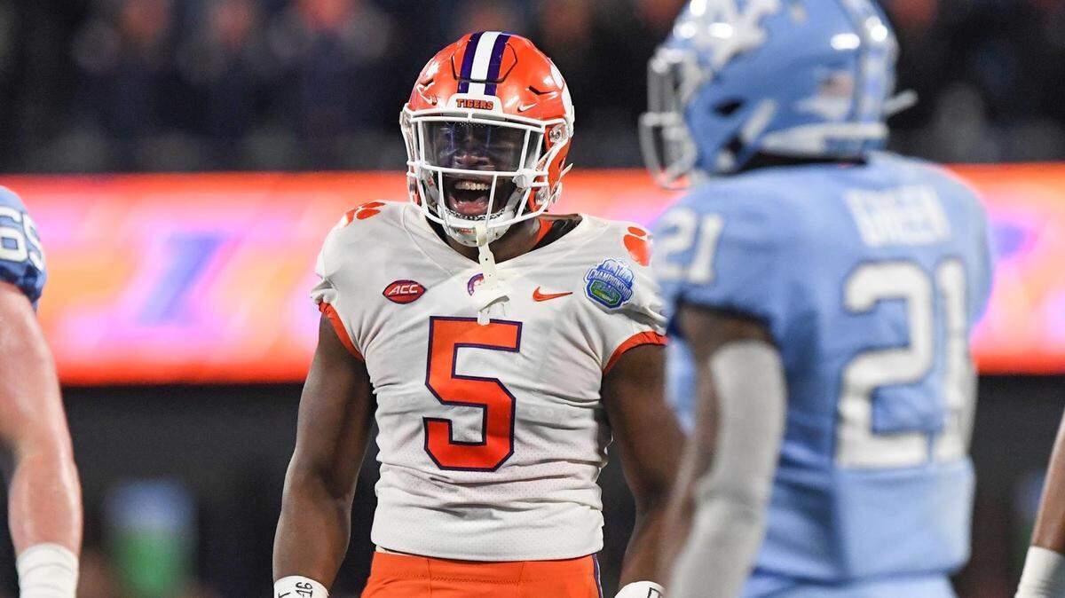 Clemson defensive end K.J. Henry (5) celebrates a defensive play near North Carolina defensive back Dontavius Nash (21) during the first quarter of the ACC Championship football game at Bank of America Stadium in Charlotte, North Carolina Saturday, Dec 3, 2022.