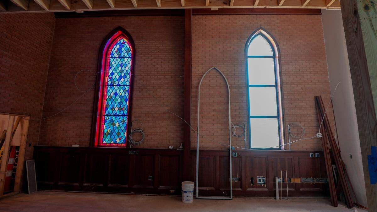 The former site of Rosewood Church is being transformed into three apartment buildings. The sanctuary of the church will include eight apartment units. The ornate stained glass windows on the sides of the sanctuary are being replaced.