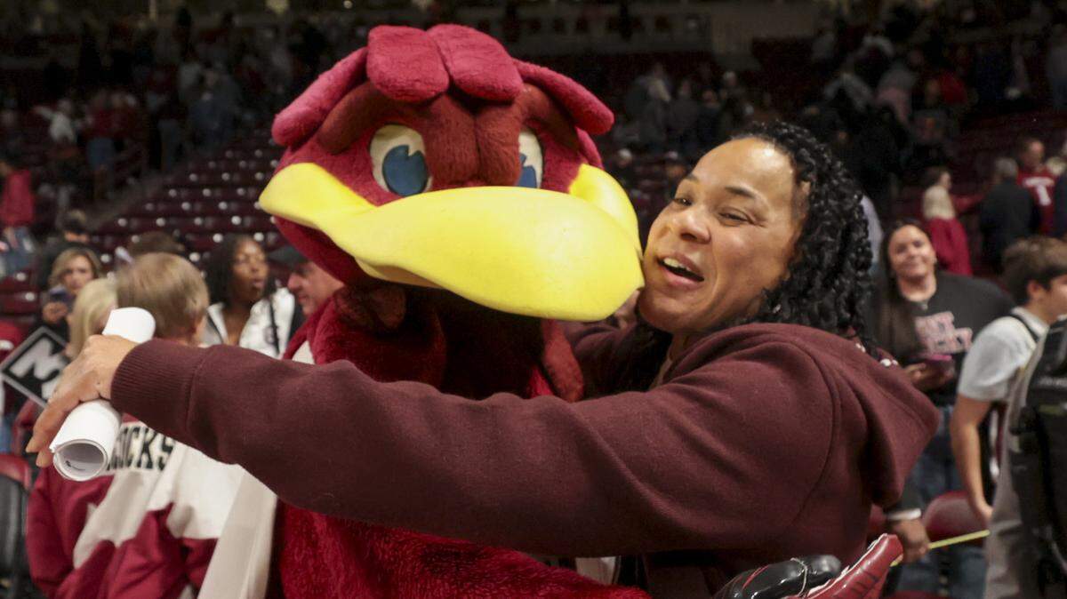 South Carolina head coach Dawn Staley embraces Cocky after their women's basketball game against Clemson at Colonial Life Arena on Tuesday, Nov. 11, 2025.