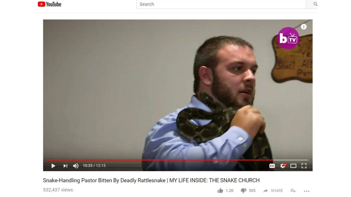 A screenshot of Pastor Cody Coots being attacked by a rattlesnake he is handling as part of a church service.