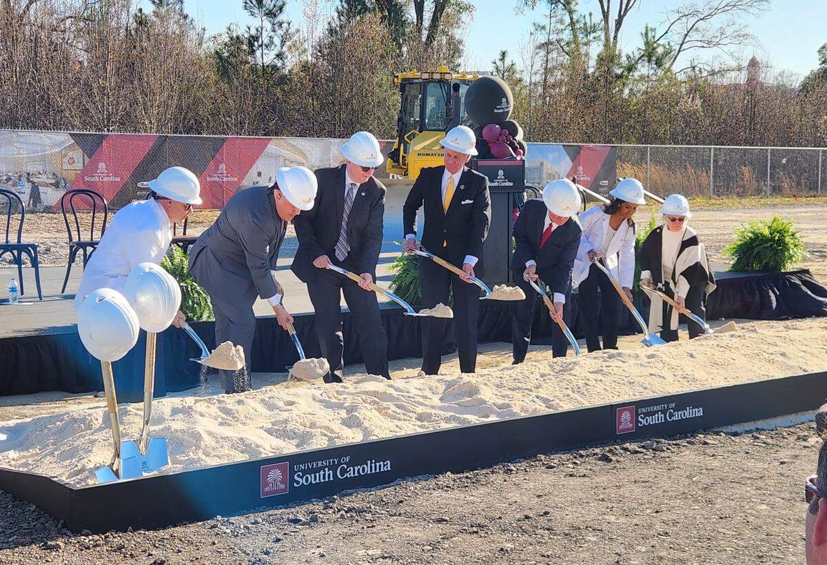 Officials including Gov. Henry McMaster, center, and USC President Michael Amiridis, third from left, break ground at the BullStreet District for the new USC School of Medicine.
