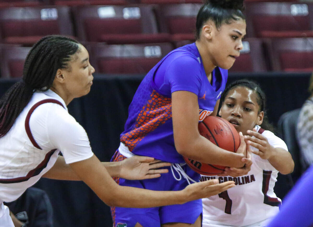 South Carolina Gamecocks forward Victaria Saxton (5) and South Carolina Gamecocks guard Zia Cooke (1) go against Florida guard Lavender Briggs (3) for a loose ball during the second half of action against Florida in the Colonial Life Arena.