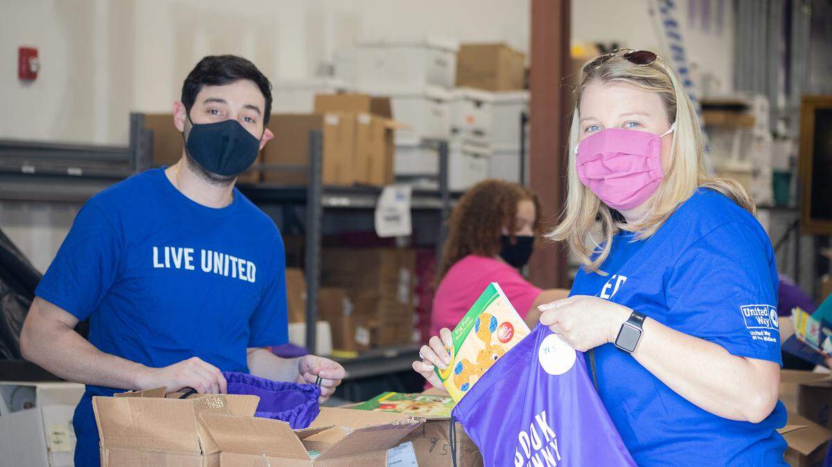 Volunteers Anthony Cortopassi with Elliott Davis and Carrie Walker with the SC Farm Bureau pack bags for the “Be A Book Bunny” initiative on April 20, 2021 during United Way’s Volunteer Week.