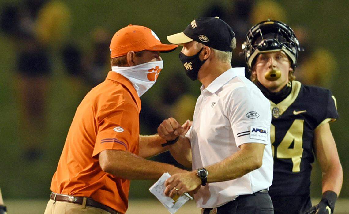 Clemson and Wake Forest players wore masks, gaiters and even face shields while on the sidelines. Here, Clemson head coach Dabo Swinney and Wake Forest head coach Dave Clawson meet at midfield after their game, both wearing face coverings.