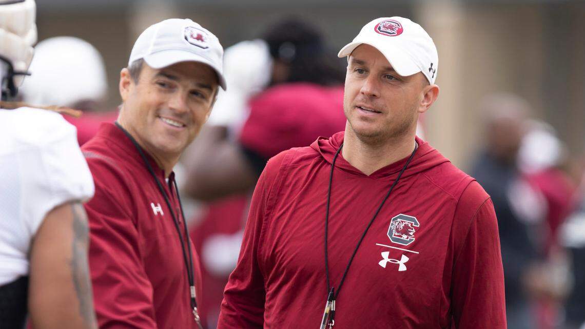 South Carolina wide receivers coach Justin Stepp speaks to head coach Shane Beamer during the Gamecocks’ practice in Columbia on Thursday, March 23, 2023.