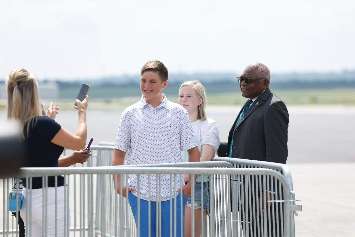 Rep. James Clyburn takes a photo with members of the public Thursday at the Columbia Metropolitan Airport before President Joe Biden’s arrival.