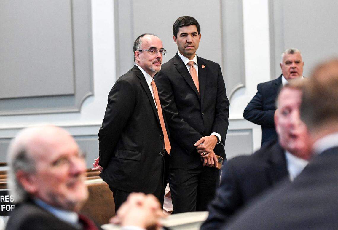 Graham Neff, middle right, Clemson University Athletic Director talks with Chip Harris, middle left, before a hearing about Clemson and the ACC before Judge Perry H. Gravely, ruling on the university’s motion for summary judgement and the conference’s motion to dismiss, at the Pickens County Courthouse in Pickens, S.C. Friday, July 12, 2024.