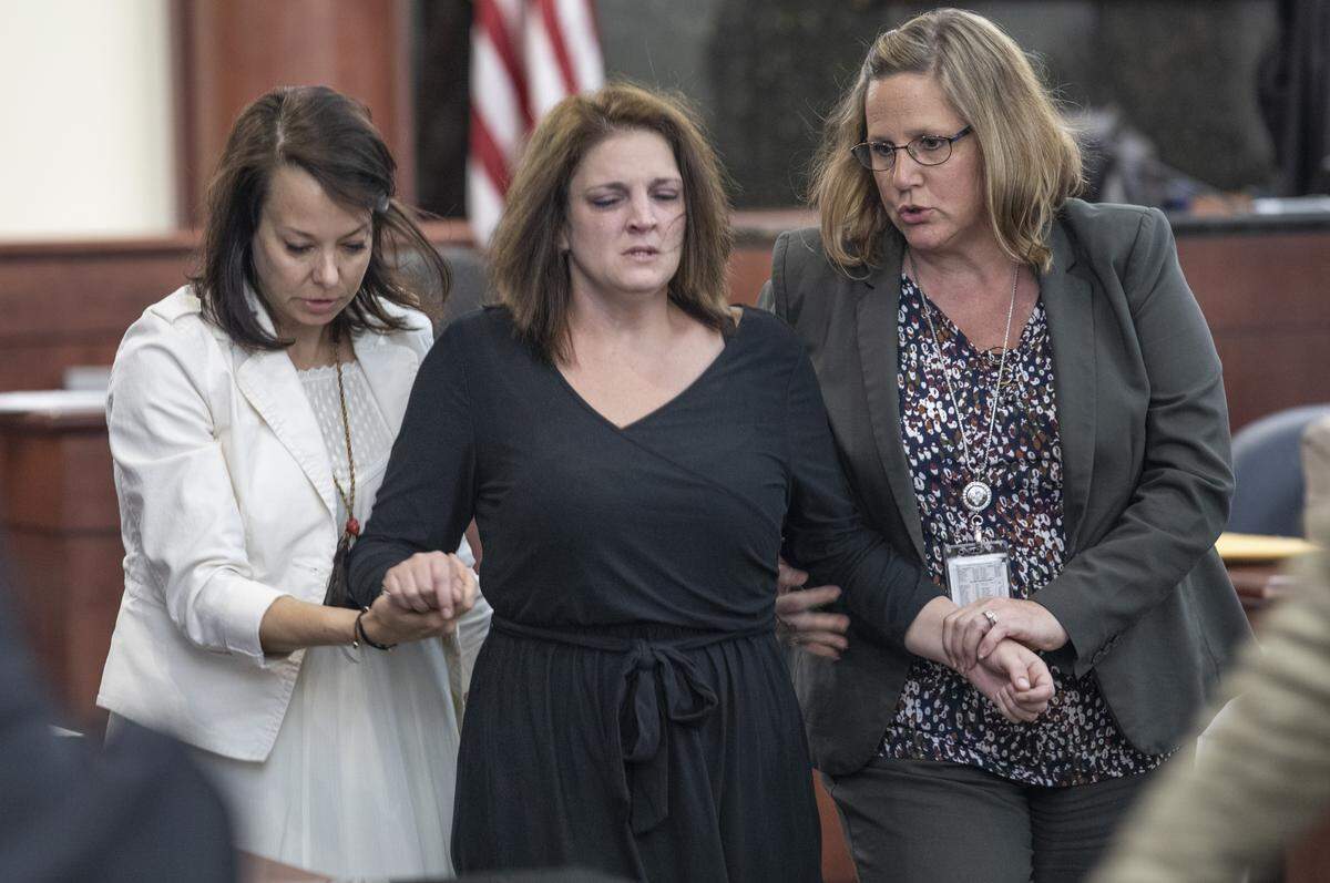 Amber Kyzer is helped out of the courtroom during the trial of her ex-husband, Tim Jones, in Lexington. on Monday. Jones is accused of killing the couple’s five young children in 2014 and faces the death penalty. 5/20/19