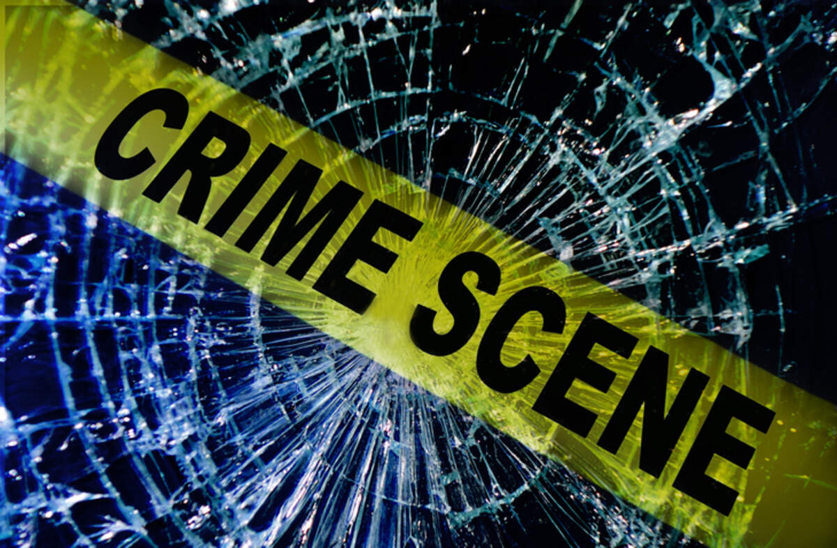Broken window with yellow Crime Scene tape