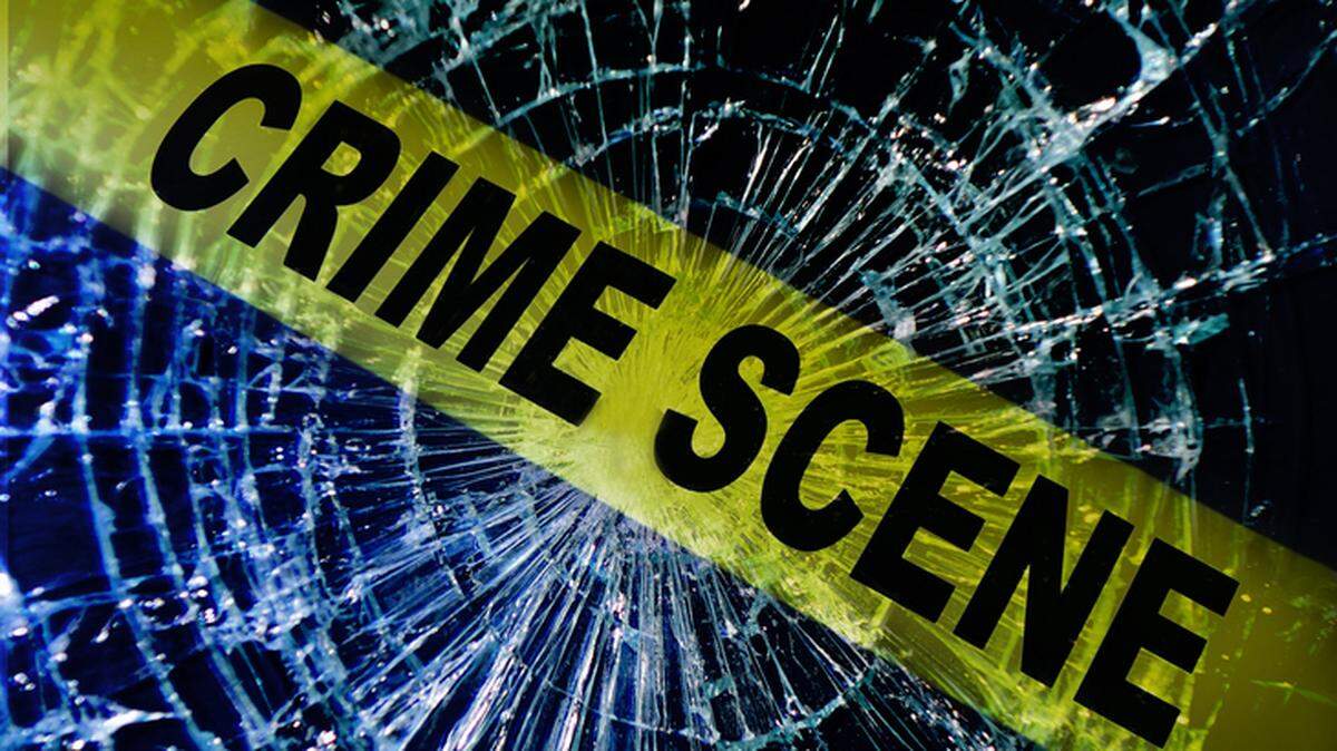 Broken window with yellow Crime Scene tape