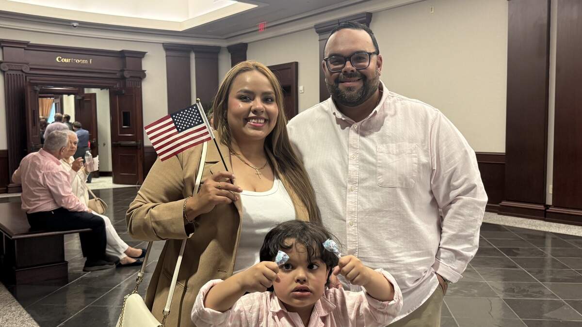Liz Ferreira, her husband Reuben Morales and their son Matteo celebrate at a reception following Ferreira’s United States Citizenship ceremony.