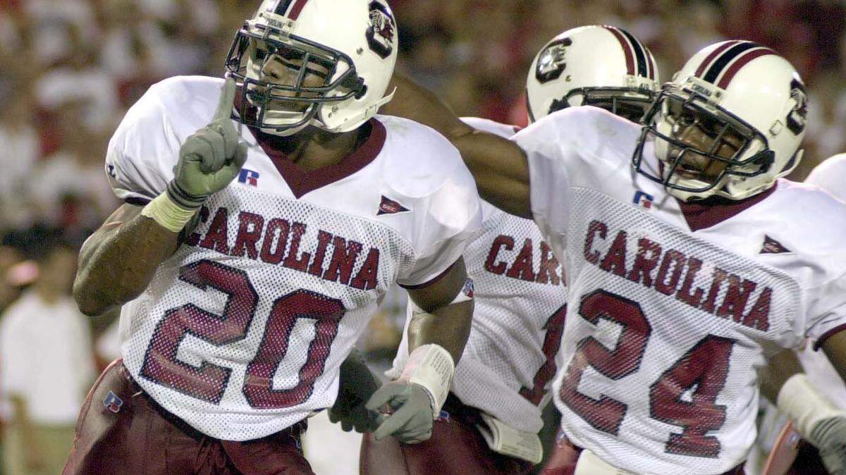 South Carolina’s Willie Offord, left, after he picked off pass for a touchdown in 2001 game against the Georgia Bulldogs.