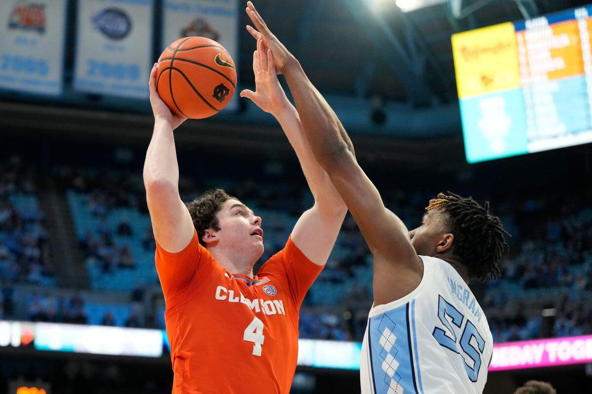 Feb 6, 2024; Chapel Hill, North Carolina, USA; Clemson Tigers forward Ian Schieffelin (4) shoots as North Carolina Tar Heels forward Harrison Ingram (55) defends in the first half at Dean E. Smith Center. Mandatory Credit: Bob Donnan-USA TODAY Sports
