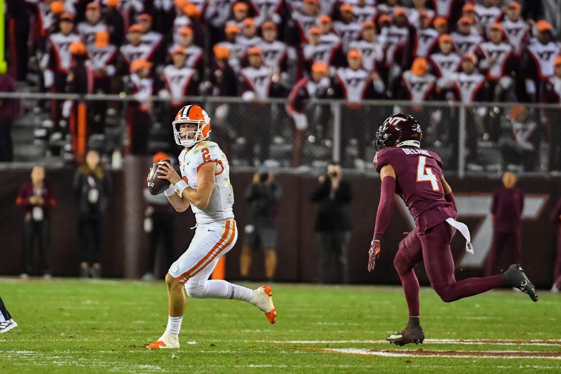 Nov 9, 2024; Blacksburg, Virginia, USA; Clemson Tigers quarterback Cade Klubnik (2) scrambles looking for a receiver while being pursued by Virginia Tech Hokies cornerback Mansoor Delane (4) during the third quarter at Lane Stadium. Mandatory Credit: Brian Bishop-Imagn Images
