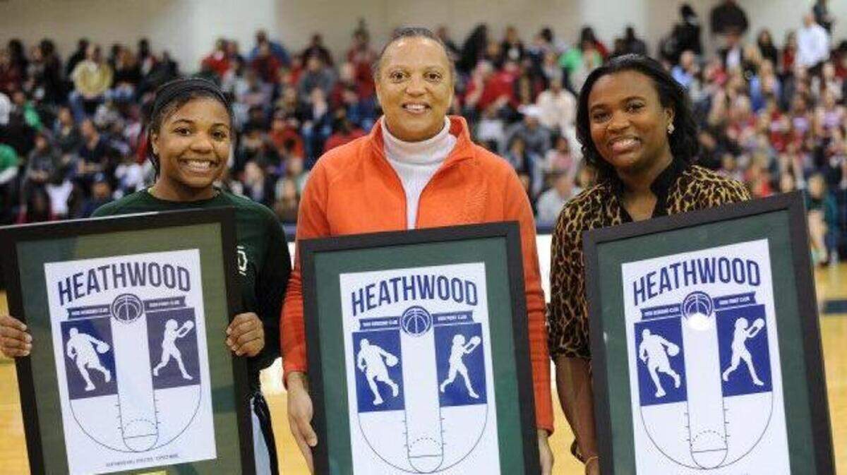 Victoria Dickerson (left) with her mother, Sandra Webber Dickerson (center, representing her daughter Kristin Dickerson), and sister Brionna Dickerson receive honors for scoring more than 1,000 career points during their time at Heathwood Hall. Kristin Dickerson, the girls basketball coach at Ben Lippen, could not attend because her team had a game.
