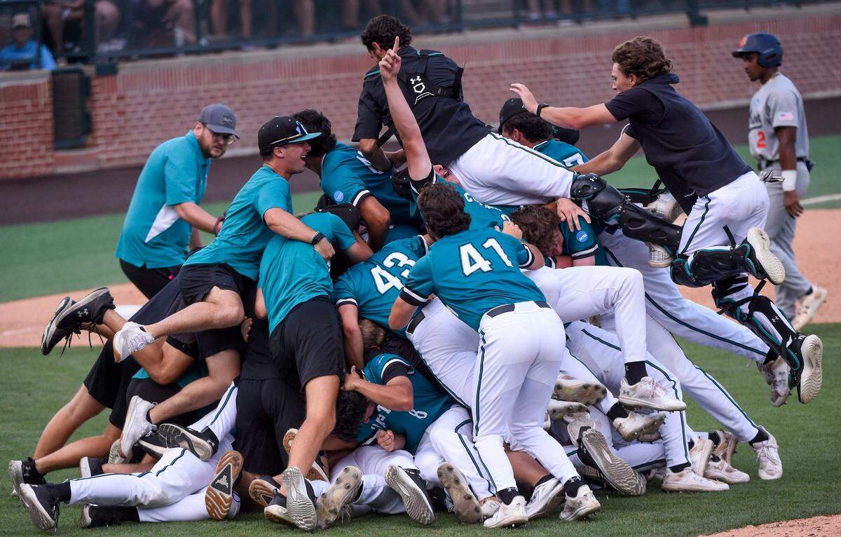 Coastal Carolina players celebrate after eliminating Auburn in the NCAA Baseball Super Regional at Plainsman Park in Auburn, Ala., on Saturday.